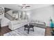 Bright and airy living room with a large sectional sofa and access to staircase at 49 Ryder Pass Way, Loganville, GA 30052