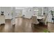 Open-concept living space with hardwood floors, large windows, and an open floor plan at 49 Ryder Pass Way, Loganville, GA 30052