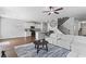 Open-concept living space with a large sectional, kitchen with a breakfast bar, and staircase at 49 Ryder Pass Way, Loganville, GA 30052
