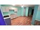 View of kitchen with white cabinets and wood laminate flooring at 497 Prince Of Wales, Stone Mountain, GA 30083