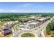 Aerial view showcasing retail and residential in a mixed use development with lush trees and green space at 530 Summerhill Dr, Roswell, GA 30075