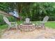 Backyard features a stone fire pit surrounded by chairs for relaxing at 530 Summerhill Dr, Roswell, GA 30075