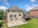 Large backyard with multi-tiered deck, basketball court, and green lawn at 530 Summerhill Dr, Roswell, GA 30075