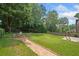 Inviting backyard with a fire pit area, lush lawn, and walking path at 530 Summerhill Dr, Roswell, GA 30075