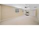 Spacious basement with neutral walls, carpet, windows, and ceiling fan at 530 Summerhill Dr, Roswell, GA 30075