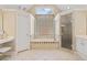 A bright bathroom features a soaking tub, walk-in shower, and double sink vanity with tile floors at 530 Summerhill Dr, Roswell, GA 30075
