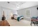 A bedroom with carpet and neutral walls features a ceiling fan and window bringing in lots of natural light at 530 Summerhill Dr, Roswell, GA 30075