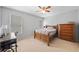 This bedroom features carpeted floors, a wooden dresser, desk, and a bed with lots of natural light at 530 Summerhill Dr, Roswell, GA 30075