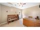 Bonus room with neutral walls, ceiling fan, bench, and wooden desk at 530 Summerhill Dr, Roswell, GA 30075