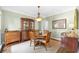 Elegant dining room with a round table, decorative lighting, and classic furnishings at 530 Summerhill Dr, Roswell, GA 30075
