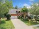 Charming two-story brick home with manicured lawn, mature trees, and a two-car garage at 530 Summerhill Dr, Roswell, GA 30075