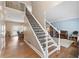 Elegant foyer with hardwood floors, a staircase with wrought iron railing, and views into the living spaces at 530 Summerhill Dr, Roswell, GA 30075