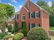 Charming two-story brick home featuring manicured landscaping and a classic architectural design at 530 Summerhill Dr, Roswell, GA 30075
