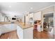 Bright kitchen with white cabinets, hardwood floors, and granite countertops at 530 Summerhill Dr, Roswell, GA 30075