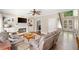 Open living room with hardwood floors, ceiling fan, fireplace and built-in shelving and cabinets at 530 Summerhill Dr, Roswell, GA 30075