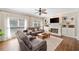 Comfortable living room with large windows, a fireplace, and built-in shelving at 530 Summerhill Dr, Roswell, GA 30075