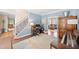 Comfortable living area with a staircase, featuring hardwood floors, light blue walls and a seamless flow into adjacent spaces at 530 Summerhill Dr, Roswell, GA 30075