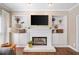 Living room with fireplace, built-in cabinets, recessed lights and large tv at 530 Summerhill Dr, Roswell, GA 30075