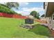 Backyard view featuring a gardening structure, storage shed, grassy lawn, and fencing at 1126 Mainstreet Valley Dr, Stone Mountain, GA 30088
