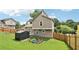 Home's backyard featuring storage shed, garden, fenced perimeter, and grassy lawn at 1126 Mainstreet Valley Dr, Stone Mountain, GA 30088
