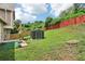 Spacious backyard featuring well-maintained lawn, storage shed, and partial fencing at 1126 Mainstreet Valley Dr, Stone Mountain, GA 30088