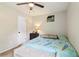 A bedroom with ceiling fan, carpet, and light gray walls at 1126 Mainstreet Valley Dr, Stone Mountain, GA 30088