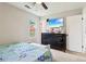 Bright bedroom with a ceiling fan, window, and a modern dresser at 1126 Mainstreet Valley Dr, Stone Mountain, GA 30088