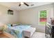 Bedroom features a ceiling fan and natural light from the window at 1126 Mainstreet Valley Dr, Stone Mountain, GA 30088