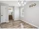 Dining room with contemporary lighting, neutral paint, and stylish flooring at 1126 Mainstreet Valley Dr, Stone Mountain, GA 30088