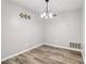 Dining room features modern light fixture, neutral paint, and attractive laminate floors at 1126 Mainstreet Valley Dr, Stone Mountain, GA 30088