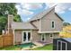 Rear exterior featuring siding, fenced yard, and a small patio area with an umbrella at 1126 Mainstreet Valley Dr, Stone Mountain, GA 30088