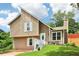 Charming split-level home featuring a unique roofline, neutral siding, and well-maintained landscaping at 1126 Mainstreet Valley Dr, Stone Mountain, GA 30088