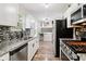 Well-lit kitchen featuring stainless steel appliances, granite countertops, and stylish backsplash at 1126 Mainstreet Valley Dr, Stone Mountain, GA 30088