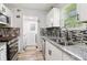 Modern kitchen featuring stainless steel appliances, granite countertops, and stylish backsplash at 1126 Mainstreet Valley Dr, Stone Mountain, GA 30088