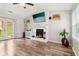 Cozy living room with a white fireplace, wood floors, and double doors to the outside at 1126 Mainstreet Valley Dr, Stone Mountain, GA 30088