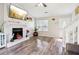 Bright living room featuring a fireplace, wood floors, and a large window for natural light at 1126 Mainstreet Valley Dr, Stone Mountain, GA 30088