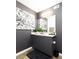 Bathroom featuring dark gray vanity, modern fixtures, and artwork at 170 Boulevard Se # E117, Atlanta, GA 30312