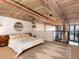 Loft bedroom featuring a comfortable bed, modern decor, and views of the city at 170 Boulevard Se # E117, Atlanta, GA 30312