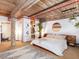 Spacious bedroom with exposed wood ceiling beams, walk-in closet, and adjacent bathroom at 170 Boulevard Se # E117, Atlanta, GA 30312
