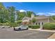 Community clubhouse with a parking lot, professional landscaping, and manicured shrubbery at 1705 Brighton Pt, Atlanta, GA 30328