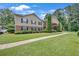 Beautiful condo building with manicured lawn, mature trees, and stone accents at 1705 Brighton Pt, Atlanta, GA 30328