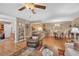 Inviting living area with hardwood floors, ceiling fan, and view of dining and kitchen at 1705 Brighton Pt, Atlanta, GA 30328