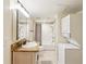 Well-lit bathroom featuring a vanity, shower-tub combo, toilet, and stacked washer/dryer at 3292 Ferncliff Ne Pl, Atlanta, GA 30324