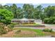Charming brick home with a lush front yard, mature trees and solar panels on the roof at 3292 Ferncliff Ne Pl, Atlanta, GA 30324