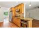A spacious kitchen featuring stainless steel appliances, granite counters, and wood cabinetry at 3292 Ferncliff Ne Pl, Atlanta, GA 30324