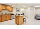 The open kitchen features stainless appliances, granite counters and an island with bar seating at 3292 Ferncliff Ne Pl, Atlanta, GA 30324