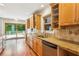 An eat-in kitchen features stainless appliances, granite counters, wood cabinets, and a glass door to the outside deck at 3292 Ferncliff Ne Pl, Atlanta, GA 30324