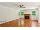 The living room features hardwood floors, a ceiling fan, and a stone fireplace at 3292 Ferncliff Ne Pl, Atlanta, GA 30324