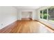 Sunlit living room with gleaming hardwood floors, white walls and large windows at 3292 Ferncliff Ne Pl, Atlanta, GA 30324