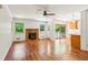 Cozy living room with hardwood floors, a brick fireplace, and access to the backyard at 3292 Ferncliff Ne Pl, Atlanta, GA 30324